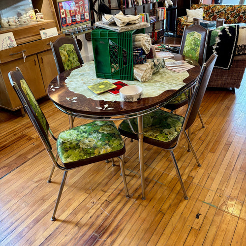 Diner-style table with chairs on a wooden floor in a store setting