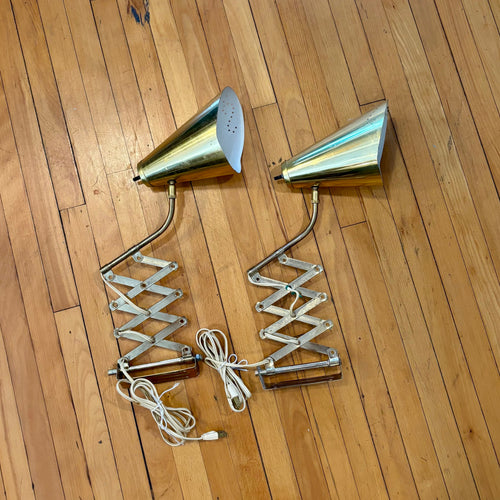 Metallic wall sconce on a wooden floor