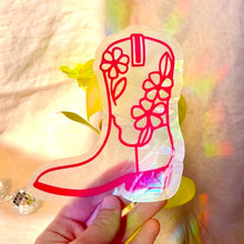 Load image into Gallery viewer, Transparent boot-shaped object with red floral designs held by a hand against a blurred background
