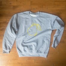 Load image into Gallery viewer, heather grey crew neck sweat shirt with neon yellow lemon graphic. &quot;suck it&quot; text outer rim of lemon
